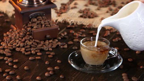 Pouring Milk into Cup of Coffee