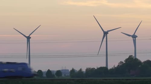 Wind Turbines Spinning as Train Passes By