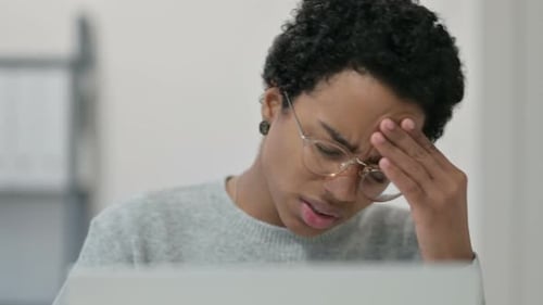 Portrait of African Woman Having Headache While Using Laptop