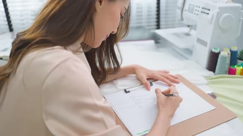 Fashion Designer Drawing a Sketch at Work