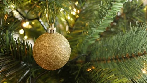 Close-up of golden color Christmas ornament 4K 2160p 30fps UltraHD footage - Shiny fairy-lights and