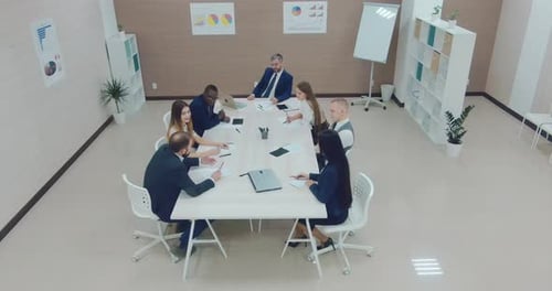 Aerial View of Team Meeting in Bright Office