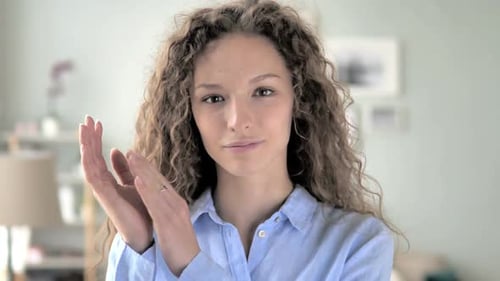 Young Woman Clapping Hands Indoors