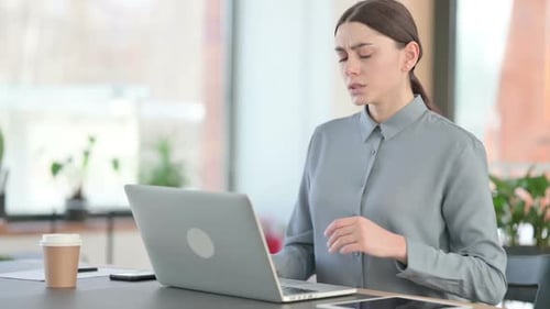 Woman Types at Laptop then Experiences Back Pain