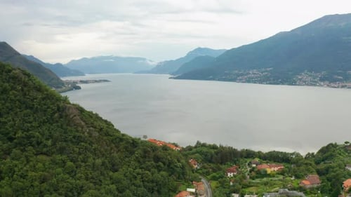 Panoramic View on a Como Lake Surrounded By Mountains Covered By Clouds Italy