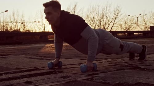 Athletic Man Exercising at Sunrise Doing Pushups