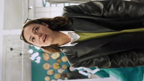 Young Girl Consultant In Clothing Store Actively Talks About The Store