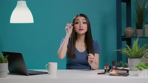 POV of Content Creator Using Mascara for Makeup Tutorial