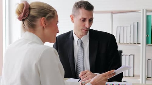 Two Happy business people discussing business ideas presentation on laptop in office