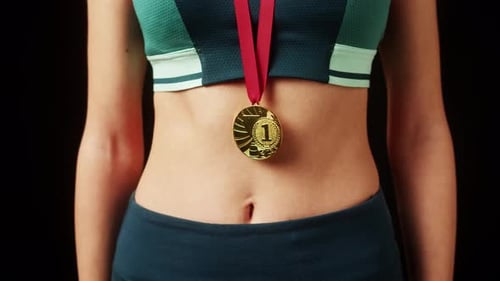Athletic Woman Wearing a Gold Medal, Close Up