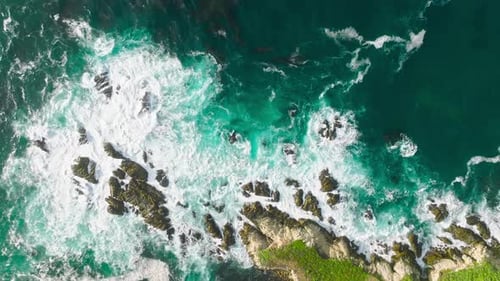 Aerial Top View Footage By Drone of Ocean Blue Waves Break on High Cliff USA