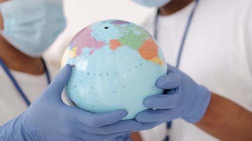 Healthcare Workers Holding Globe, Global Health Concept