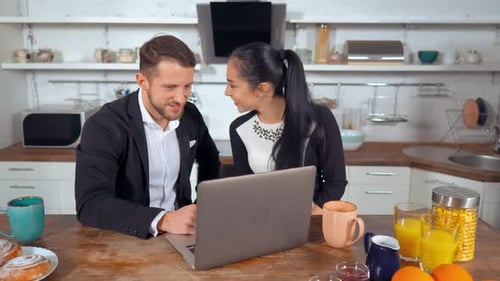 Couple Working on Laptop in Bright Kitchen