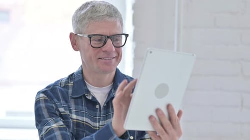 Adult Using Tablet Device Indoors