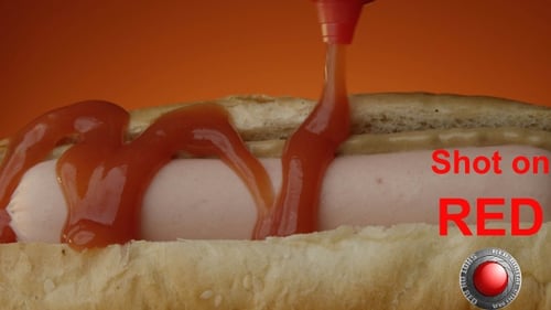 Adding Ketchup to a Hot Dog Close Up