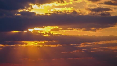 Sunset in the Sky Through Yellow Layered Clouds Timelapse