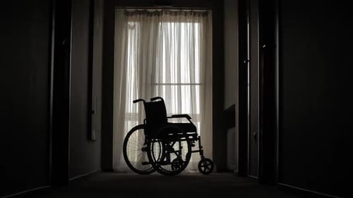 Empty Wheelchair Parked in Hospital Hallway