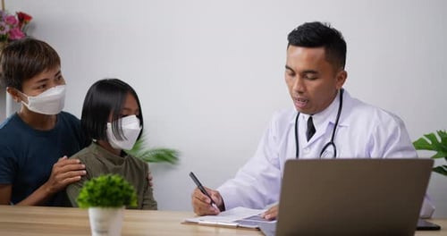 Doctor Consulting with Young Patient and Mother