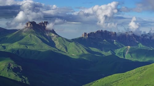 Expansive Green Mountains and Cloudy Sky Landscape