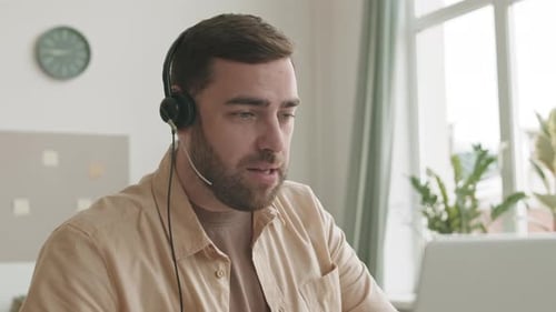 Young Adult Talks During Virtual Meeting