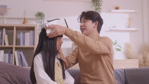 Adult Helping Child With Virtual Reality Headset