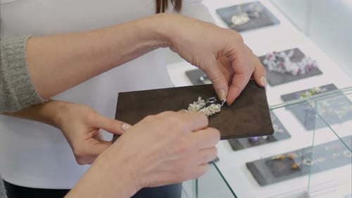 Women Earrings in Silver with White Gems in the Jewelry Store