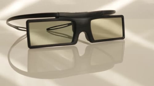 Active 3D TV glasses on white reflective surface slow tilt 4K 2160p UltraHD footage - Battery operat