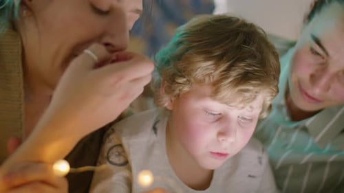 Family Gathers Around a Light Source