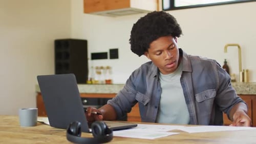 Young Adult Working on Laptop at Home