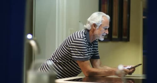 Senior Man Enjoying Tablet at Home