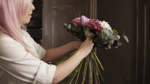 Woman Arranging a Beautiful Flower Bouquet