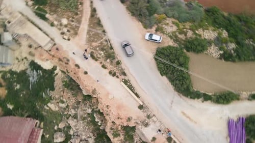 An aerial view of Coastal Dirty Road where cars are running through the road. The roads are very dir