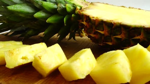 Pineapple Chunks with Half Pineapple on Cutting Board