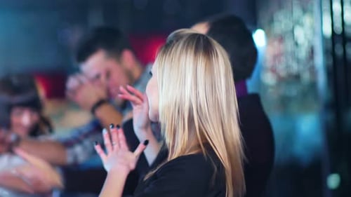 Enthusiastic Young Adults Dancing at Lively Nightclub Event