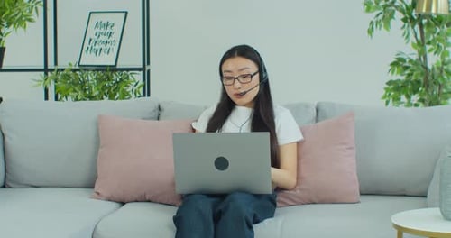 Woman on Laptop Video Call in Living Room