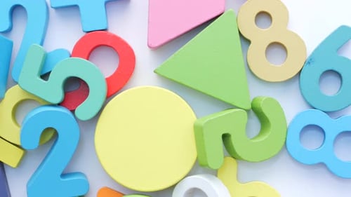 Colorful Plastic Letters on Orange Background Top View