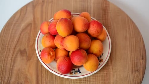 Pile of Ripe Apricots on Plate Rotating