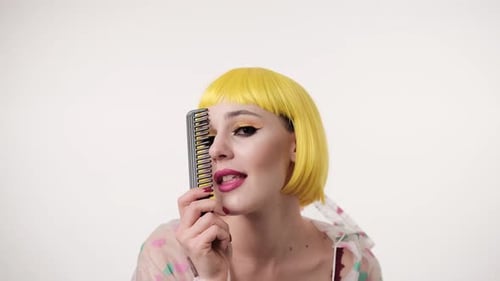 Woman in Yellow Wig Plays with a Comb