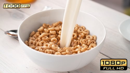 Pouring Milk into Bowl of Circle-Shaped Cereals