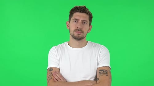Portrait of Confident Guy Is Looking Straight and Crossing His Arms Over His Chest