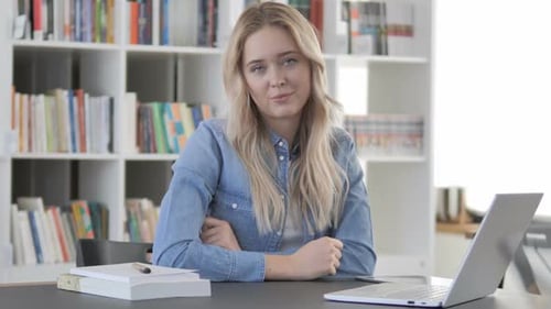 Young Woman Talking Toward Camera in Office