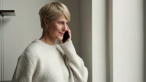 Woman Talking on Mobile Phone Indoors