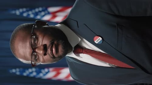 Man in Suit With "Vote" Button