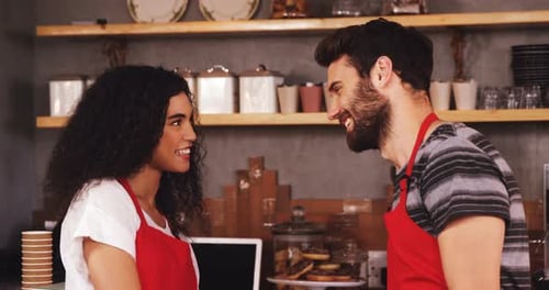 Smiling Baristas at Work in a Cafe