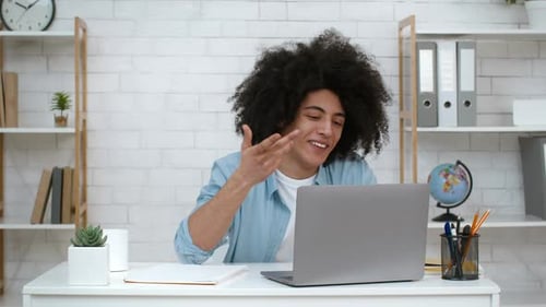 Young Adult Video Conferencing at Desk Indoors
