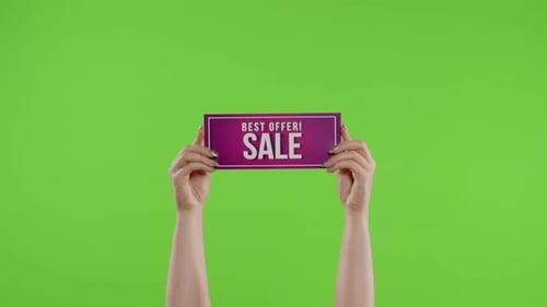 Best Offer Sale Advertisement Inscription on Paper Sheet in Womans Hands on Chroma Key. Slow Motion