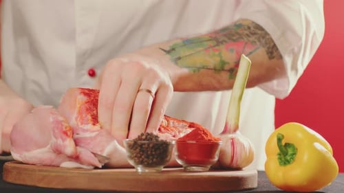 Chef cutting raw meat with sharp knife
