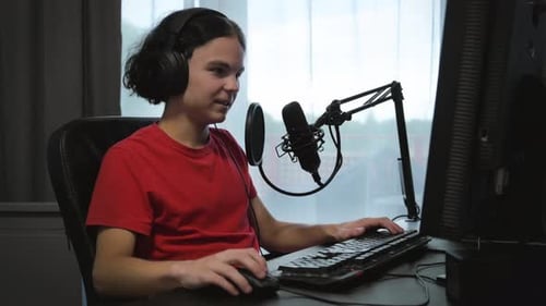 Young Man Recording Podcast at Computer Workstation