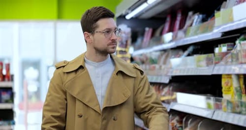 Man Chooses Products in the Grocery Store Put It to the Cart