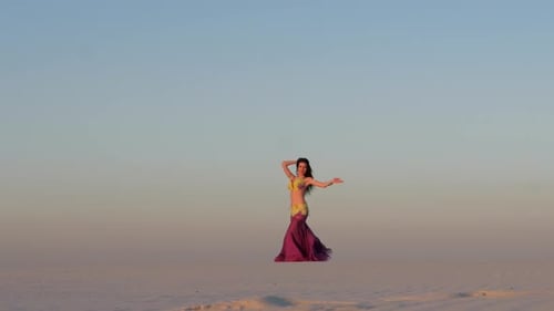 Woman Belly Dancing in Desert at Sunrise
